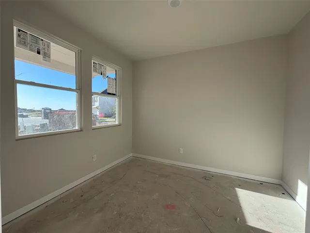 a view of kitchen with stainless steel appliances granite countertop a stove a sink a refrigerator and white cabinets