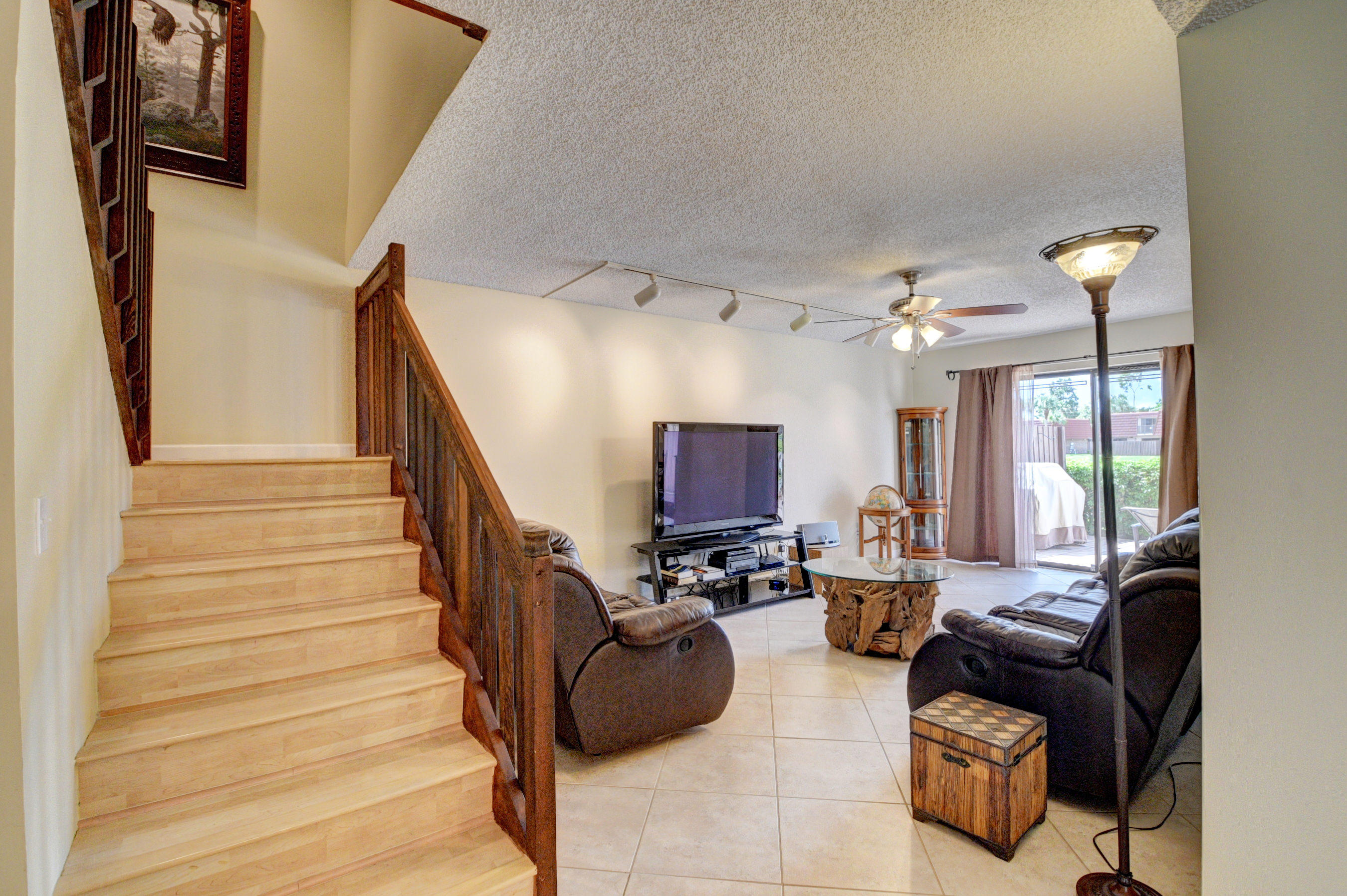 8165 Boca Rio Drive Boca Raton, FL 33433 - Photo 20 of 49 a living room with furniture and a chandelier