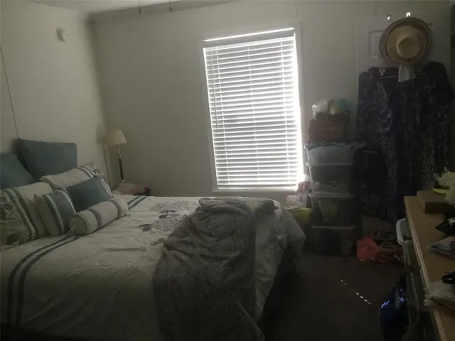 a bed sitting in a bedroom next to a window