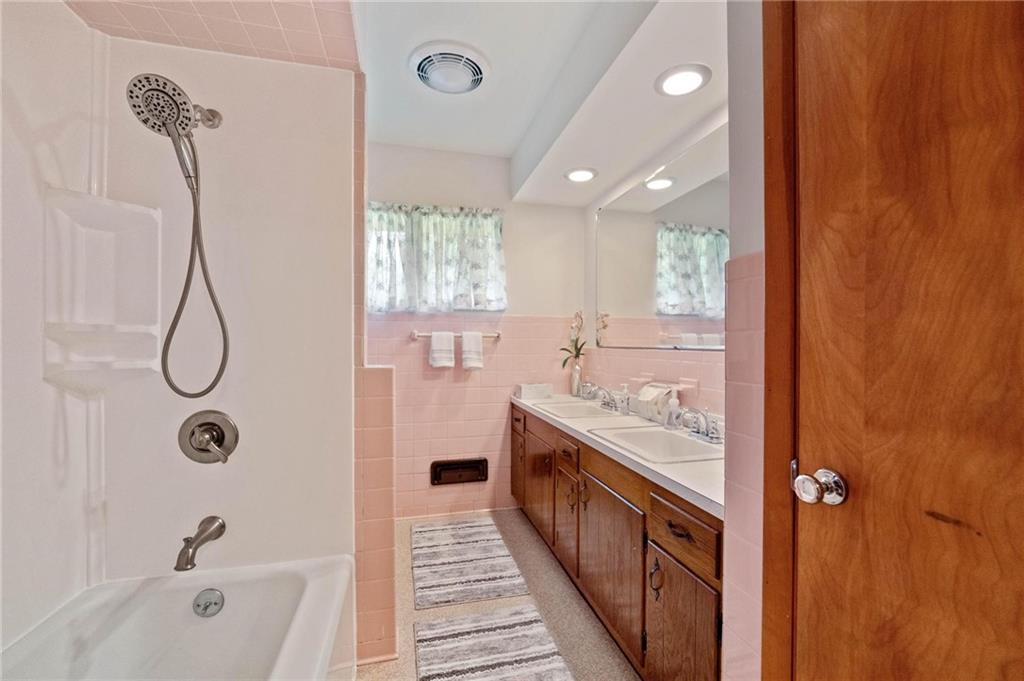 51 Lover Jonestown Road Charleroi, PA 15022 - Photo 16 of 24 a bathroom with a granite countertop sink a mirror and a bathtub