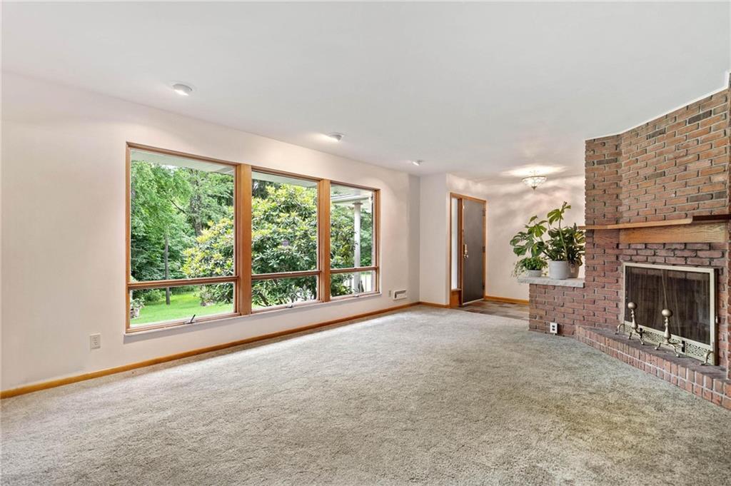 51 Lover Jonestown Road Charleroi, PA 15022 - Photo 2 of 24 a view of an empty room with a fireplace and a window
