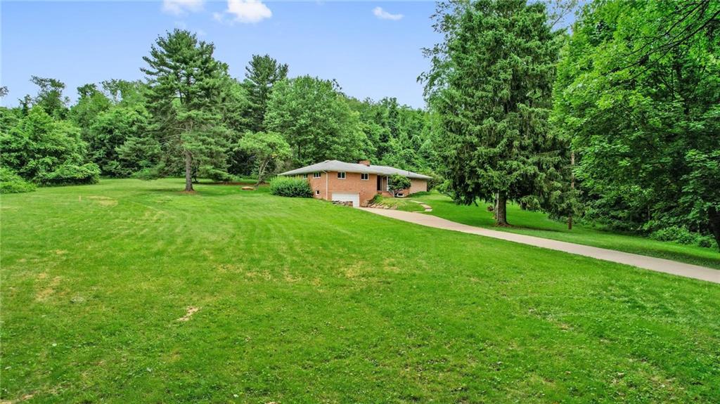 51 Lover Jonestown Road Charleroi, PA 15022 - Photo 22 of 24 a backyard of a house with large trees and plants
