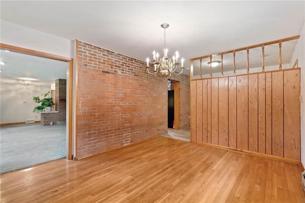 51 Lover Jonestown Road Charleroi, PA 15022 - Photo 6 of 24 a view of a hallway with wooden floor and chandelier