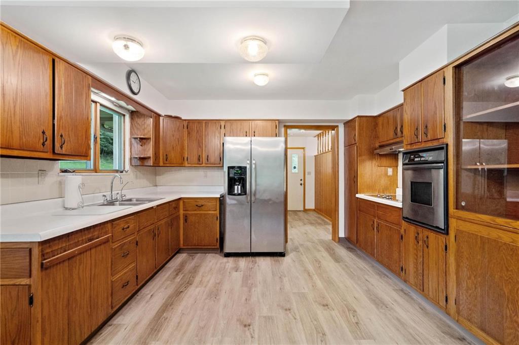 51 Lover Jonestown Road Charleroi, PA 15022 - Photo 8 of 24 a kitchen with stainless steel appliances a sink cabinets and wooden floor