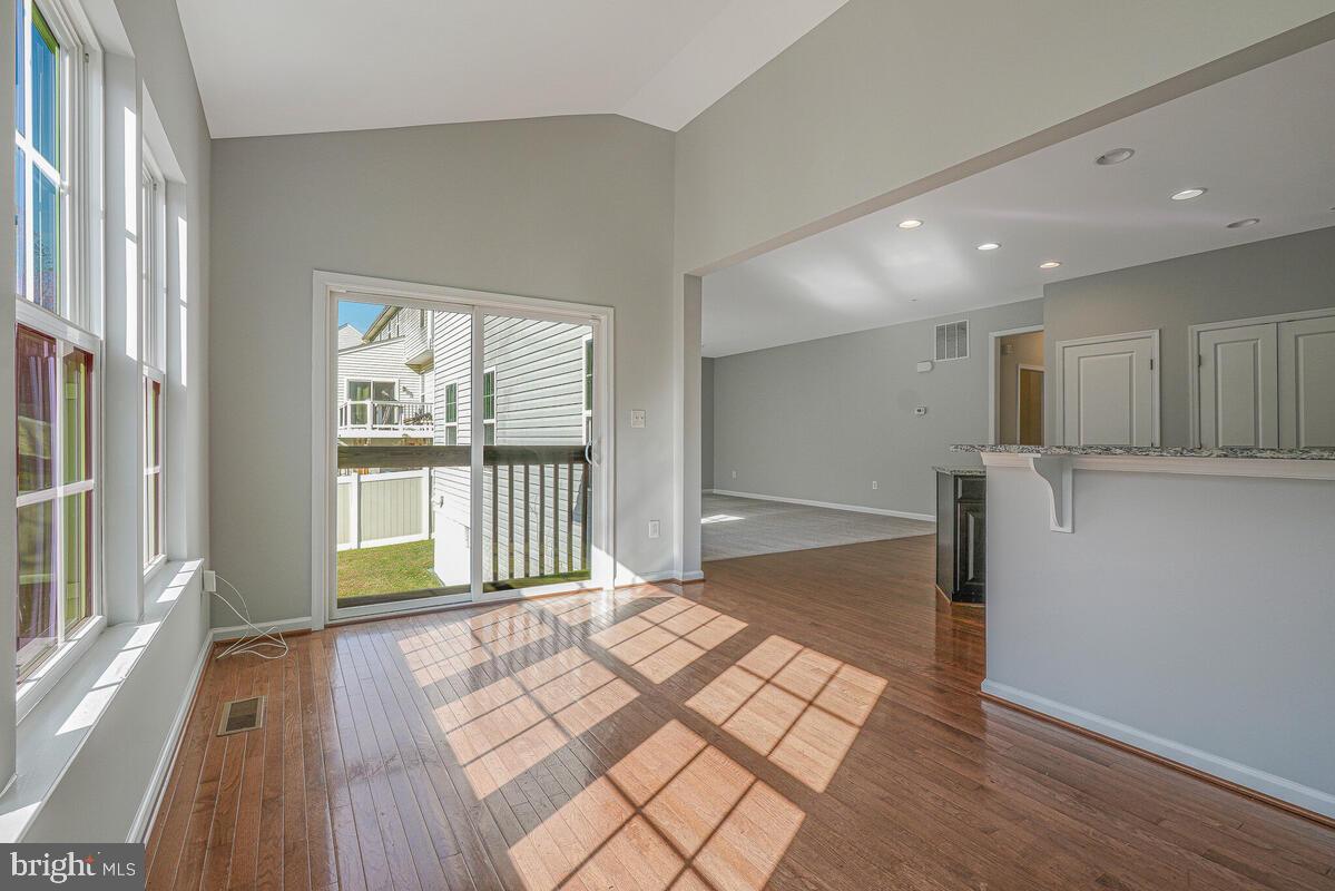 6911 Simmons Lane Clinton, MD 20735 - Photo 14 of 41 a view of empty room with wooden floor and fan