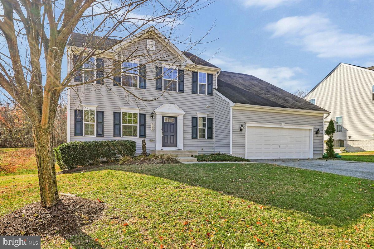 6911 Simmons Lane Clinton, MD 20735 - Photo 2 of 41 a front view of a house with a yard and garage