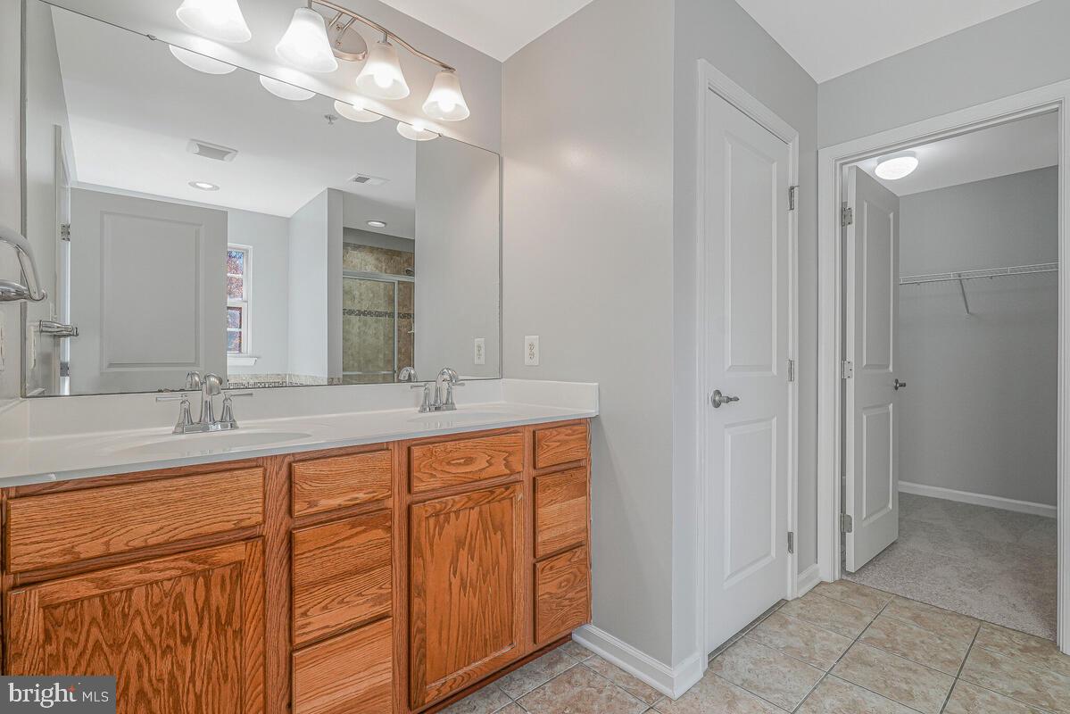 6911 Simmons Lane Clinton, MD 20735 - Photo 35 of 41 a bathroom with double sink and a mirror