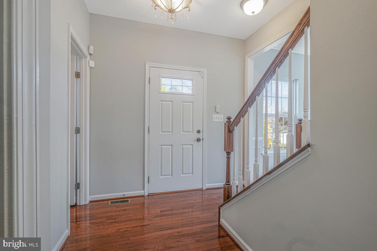 6911 Simmons Lane Clinton, MD 20735 - Photo 5 of 41 a view of an entryway with wooden floor