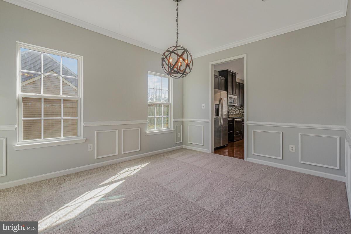 6911 Simmons Lane Clinton, MD 20735 - Photo 7 of 41 an empty room with windows and cabinet
