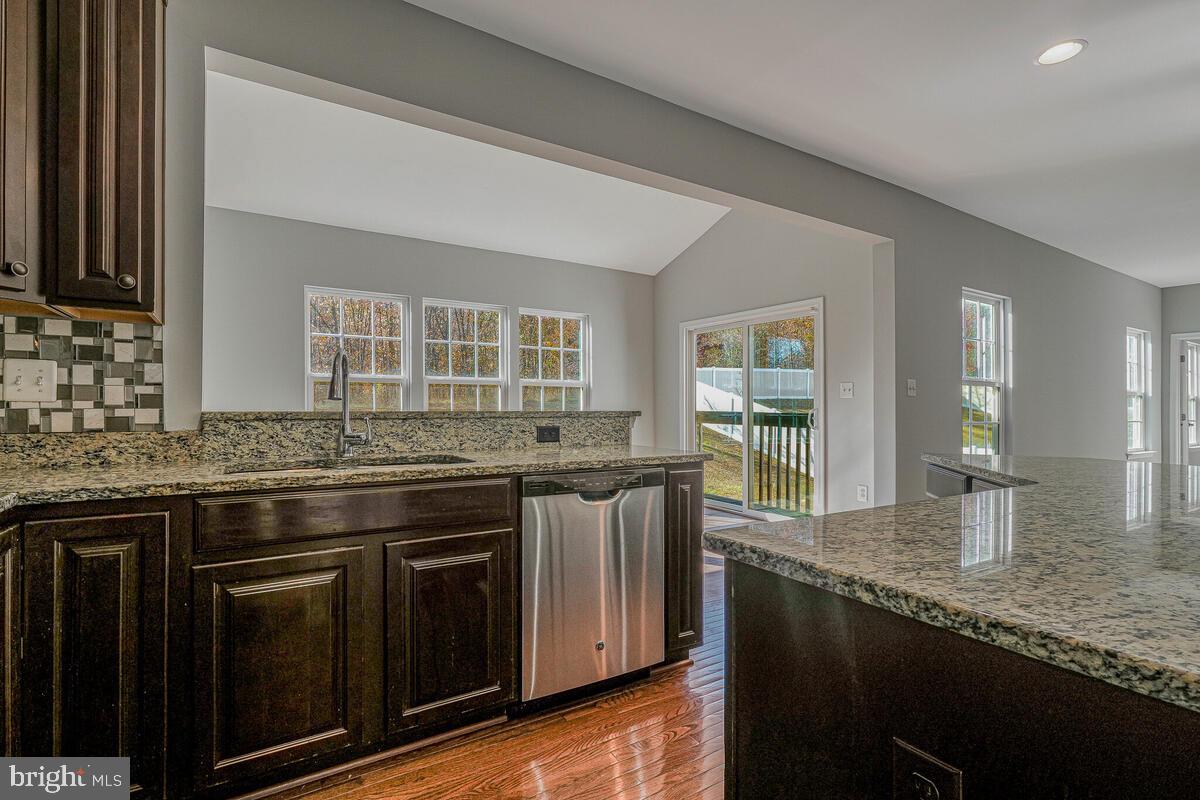 6911 Simmons Lane Clinton, MD 20735 - Photo 8 of 41 a kitchen with stainless steel appliances granite countertop a stove and a sink
