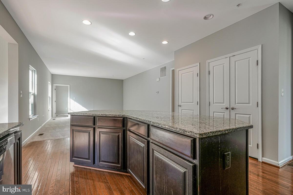 6911 Simmons Lane Clinton, MD 20735 - Photo 10 of 41 a kitchen with stainless steel appliances granite countertop a refrigerator and a sink