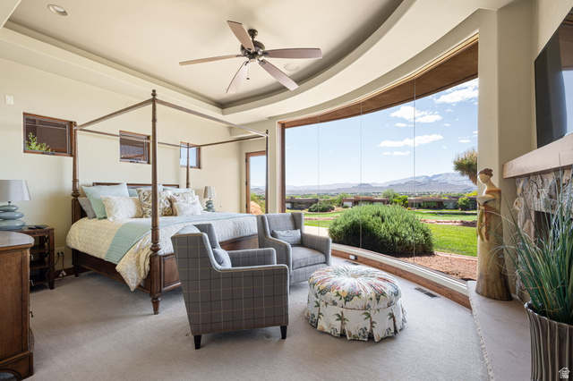2331 West Entrada Trail, Unit 61 St. George, UT 84770 - Photo 24 of 69 Spacious room featuring a curved window wall, tray ceiling, recessed lighting, and a ceiling fan