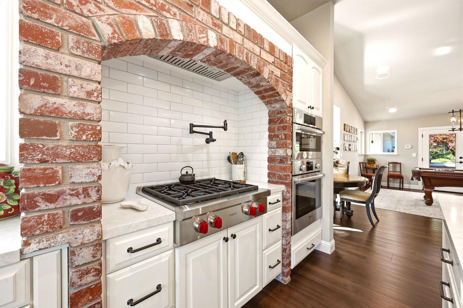 6380 Butterfield Way Placerville, CA 95667 - Photo 30 of 93 a kitchen with stainless steel appliances granite countertop a stove and a wooden cabinets