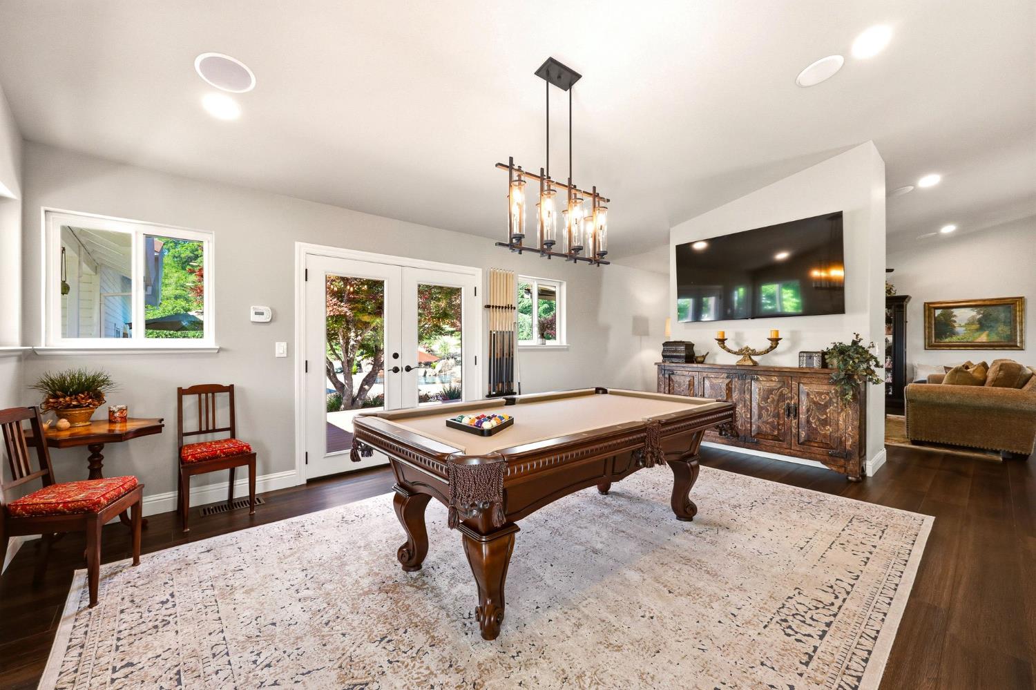 6380 Butterfield Way Placerville, CA 95667 - Photo 36 of 93 a living room with furniture a flat screen tv and a dining table