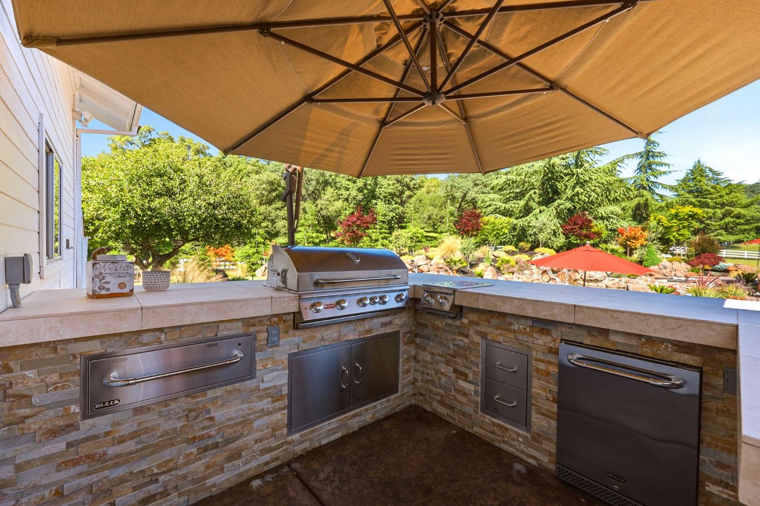 6380 Butterfield Way Placerville, CA 95667 - Photo 55 of 93 a table and chair under an umbrella in backyard
