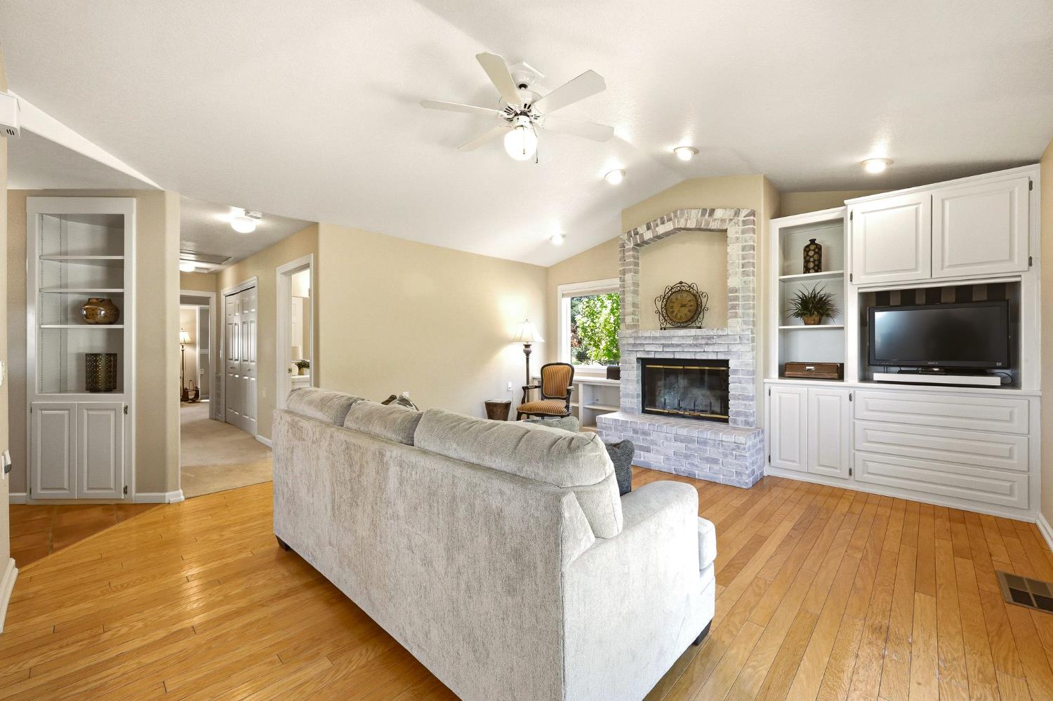 6380 Butterfield Way Placerville, CA 95667 - Photo 65 of 93 a living room with furniture a flat screen tv and a fireplace