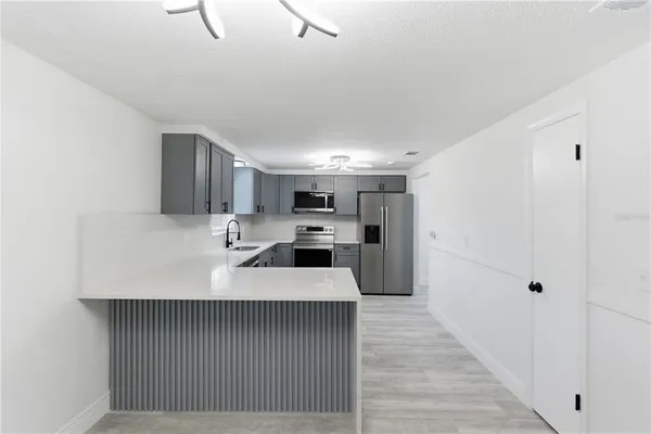 a large white kitchen with a sink