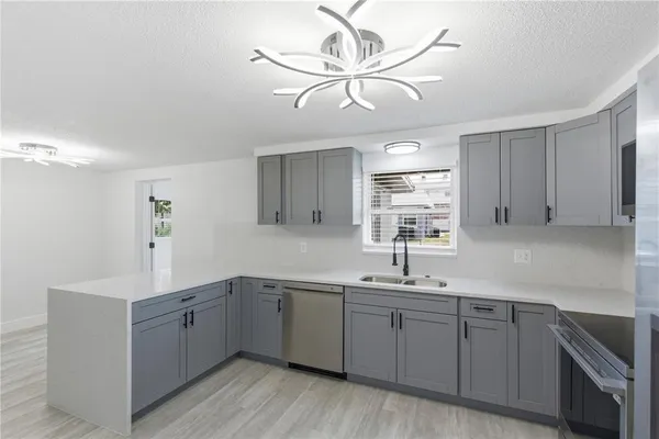 a kitchen with a sink cabinets and window