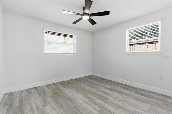 a view of empty room with wooden floor