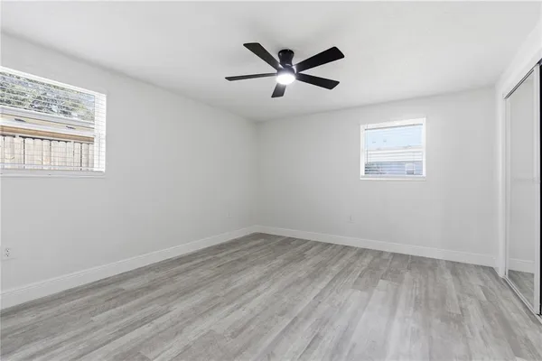 a view of empty room with wooden floor
