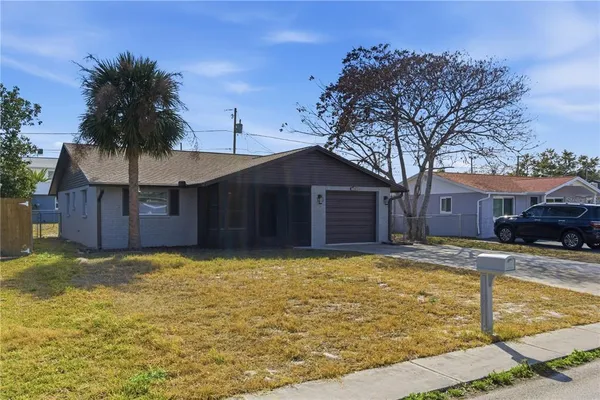 a view of a house with a yard covered with snow in front of house