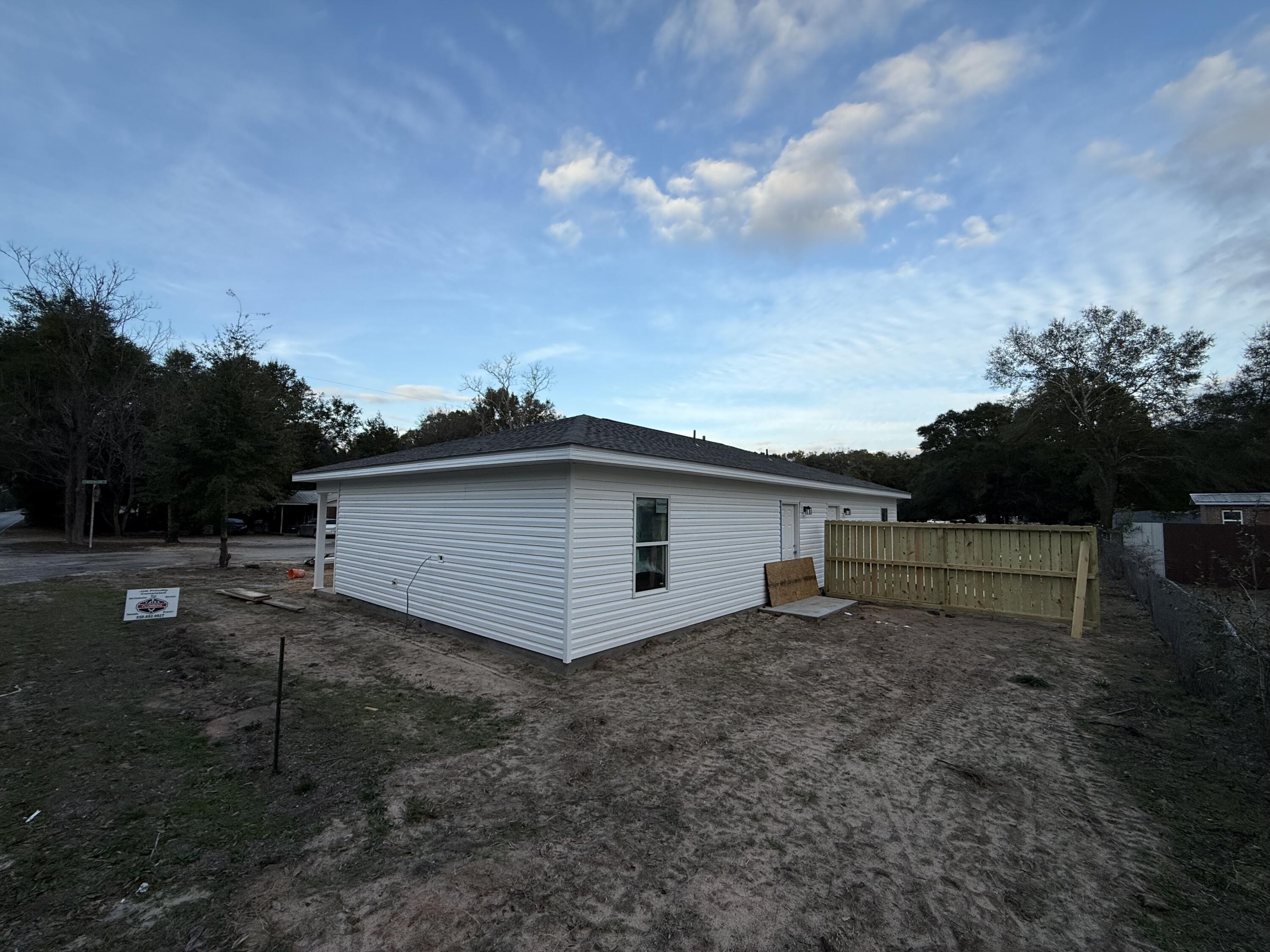 32 Constitution Avenue, Unit AB DeFuniak Springs, FL 32433 - Photo 13 of 13 a view of a house with a yard