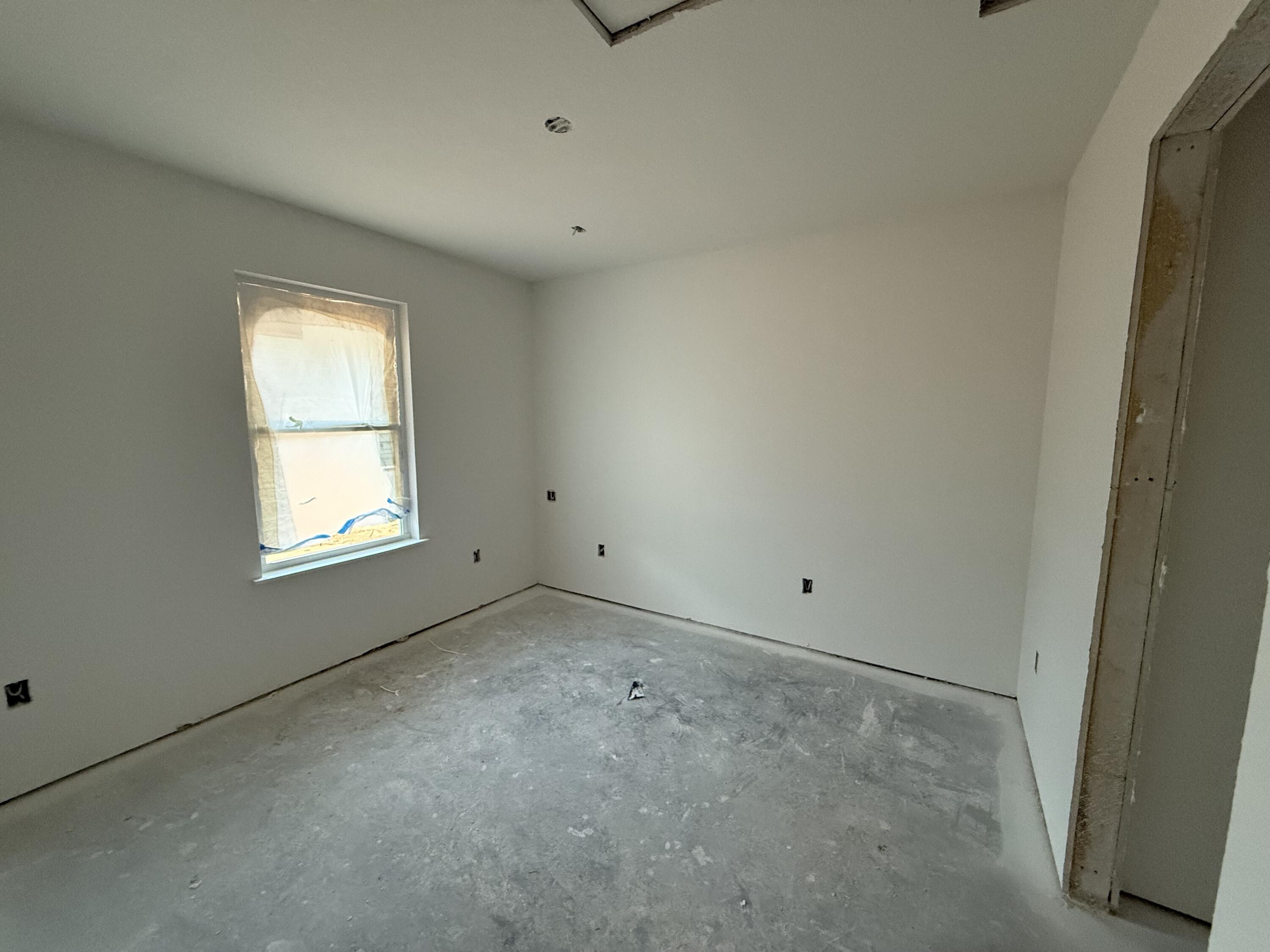 32 Constitution Avenue, Unit AB DeFuniak Springs, FL 32433 - Photo 9 of 13 a view of an empty room with a window