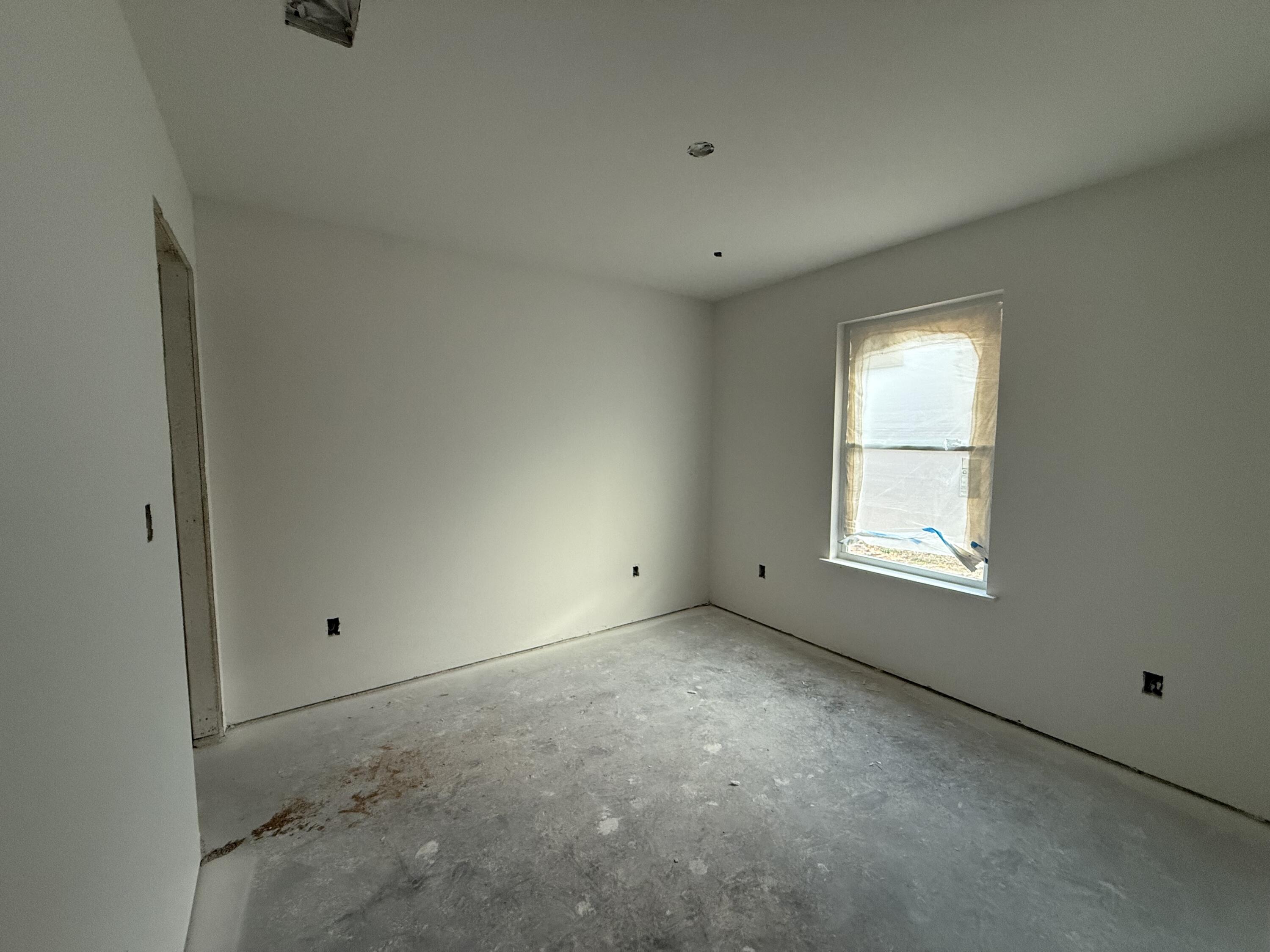32 Constitution Avenue, Unit AB DeFuniak Springs, FL 32433 - Photo 10 of 13 a view of an empty room with a window