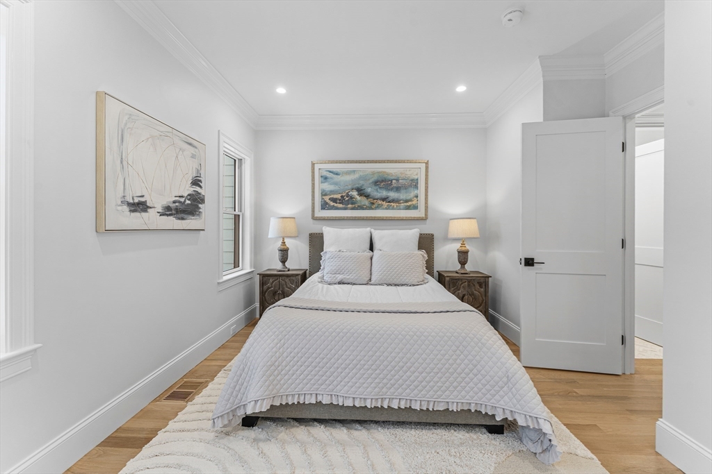 126 Prince Street Needham, MA 02492 - Photo 16 of 26 a spacious bedroom with a bed and a painting on the wall