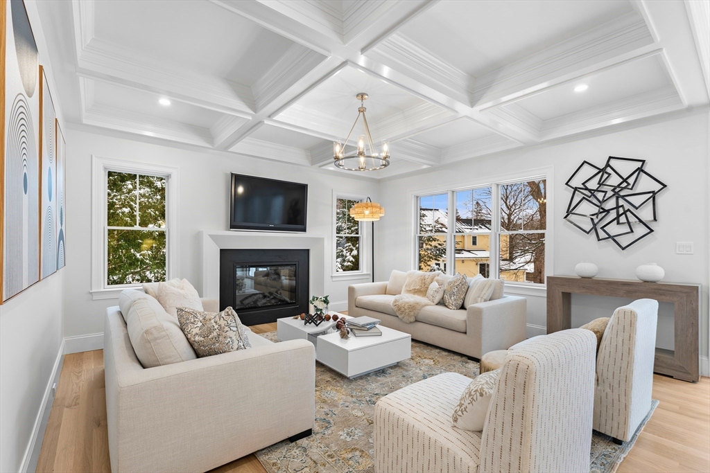 126 Prince Street Needham, MA 02492 - Photo 2 of 26 a living room with furniture a fireplace and a flat screen tv