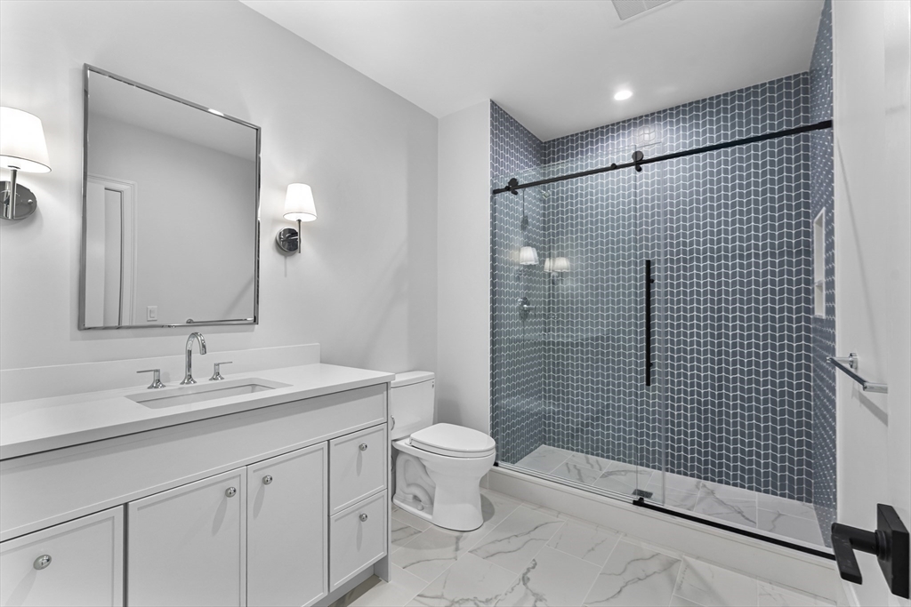 126 Prince Street Needham, MA 02492 - Photo 23 of 26 a bathroom with a sink a toilet and shower