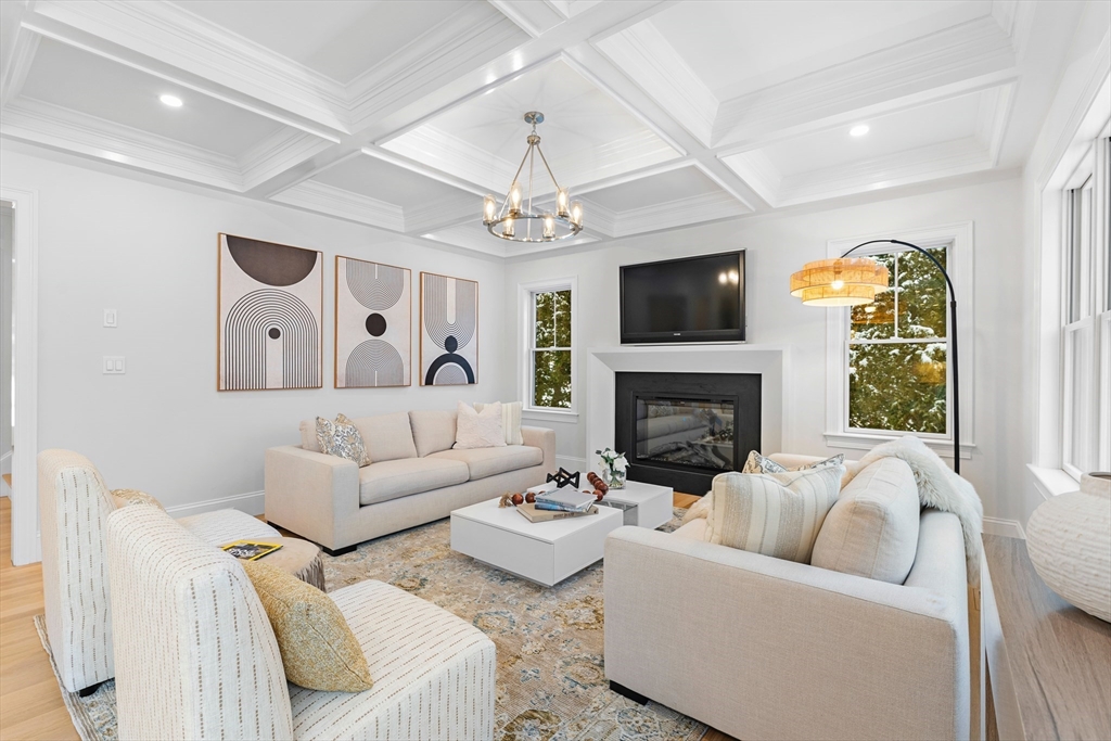 126 Prince Street Needham, MA 02492 - Photo 3 of 26 a living room with furniture a flat screen tv and a fireplace