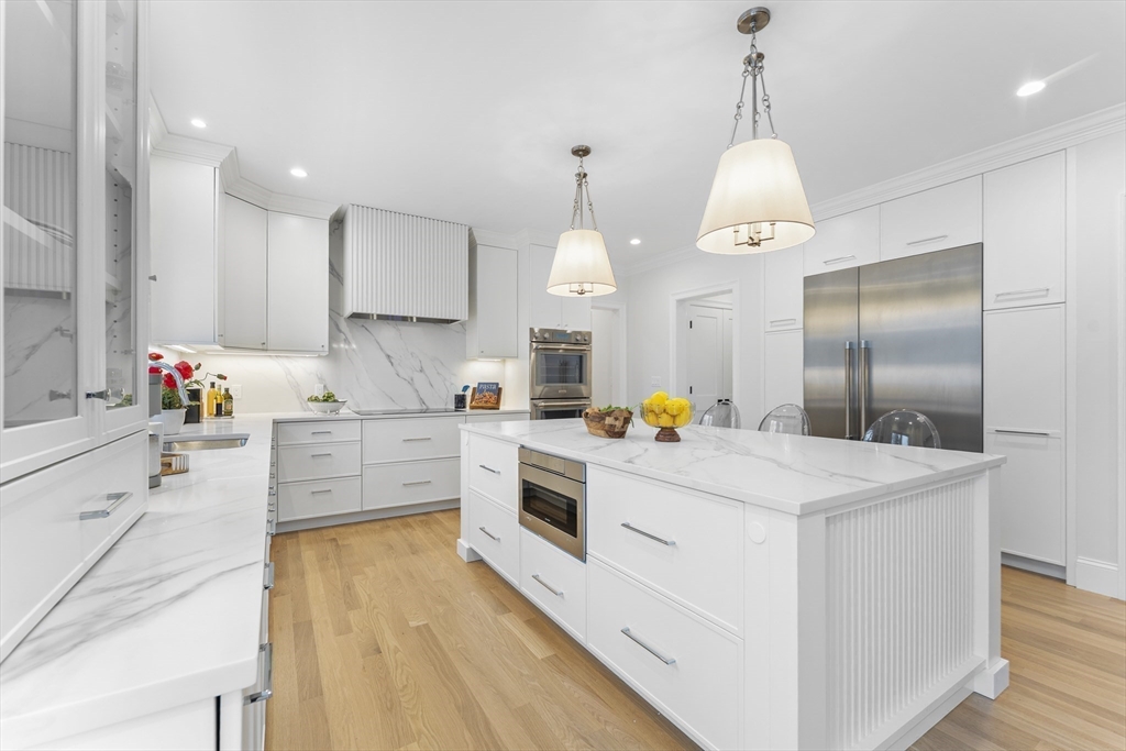 126 Prince Street Needham, MA 02492 - Photo 7 of 26 a kitchen that has a lot of cabinets and wooden floor