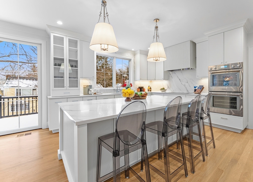 126 Prince Street Needham, MA 02492 - Photo 8 of 26 a dining room with furniture a chandelier and wooden floor