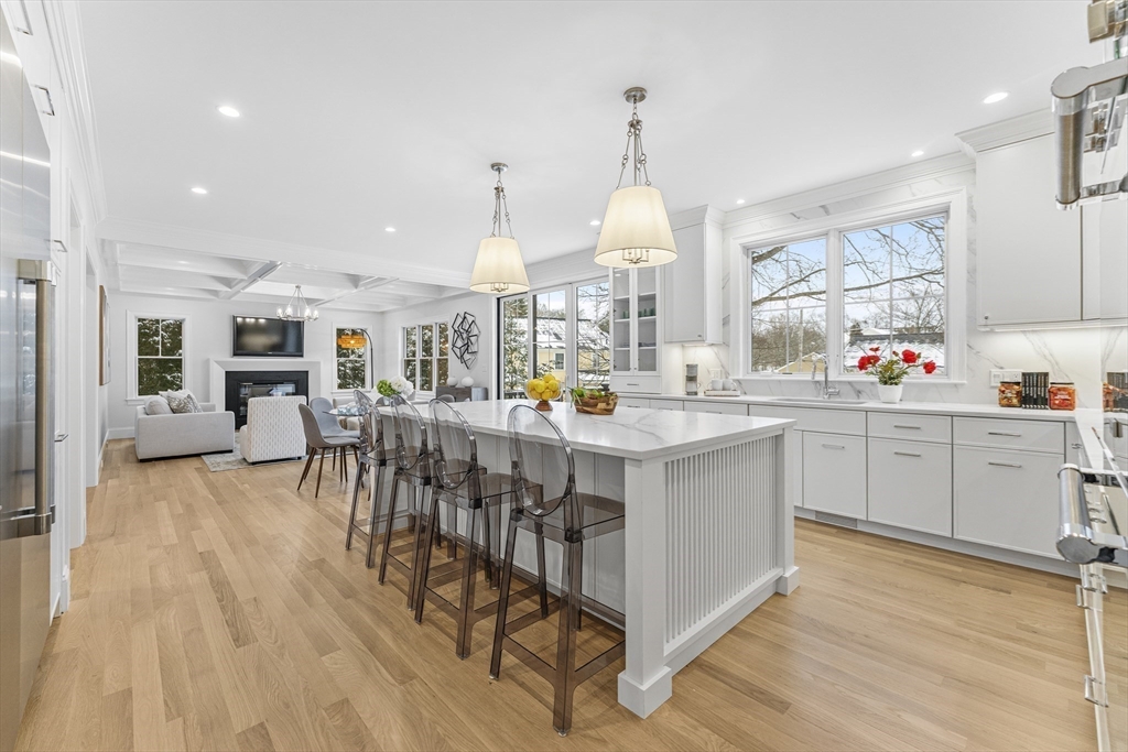 126 Prince Street Needham, MA 02492 - Photo 10 of 26 a kitchen with kitchen island granite countertop a sink cabinets and wooden floor