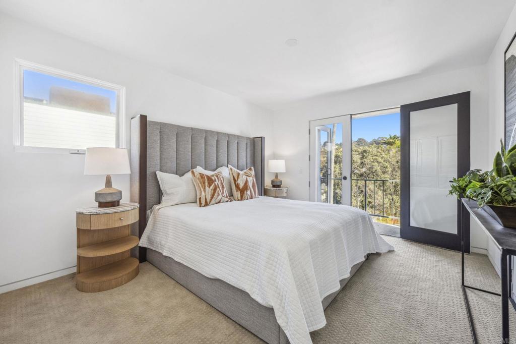 1716 Ocean Front Del Mar, CA 92014 - Photo 46 of 61 a spacious bedroom with a bed and a potted plant