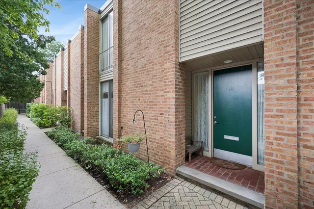 a view of a brick house with a large windows