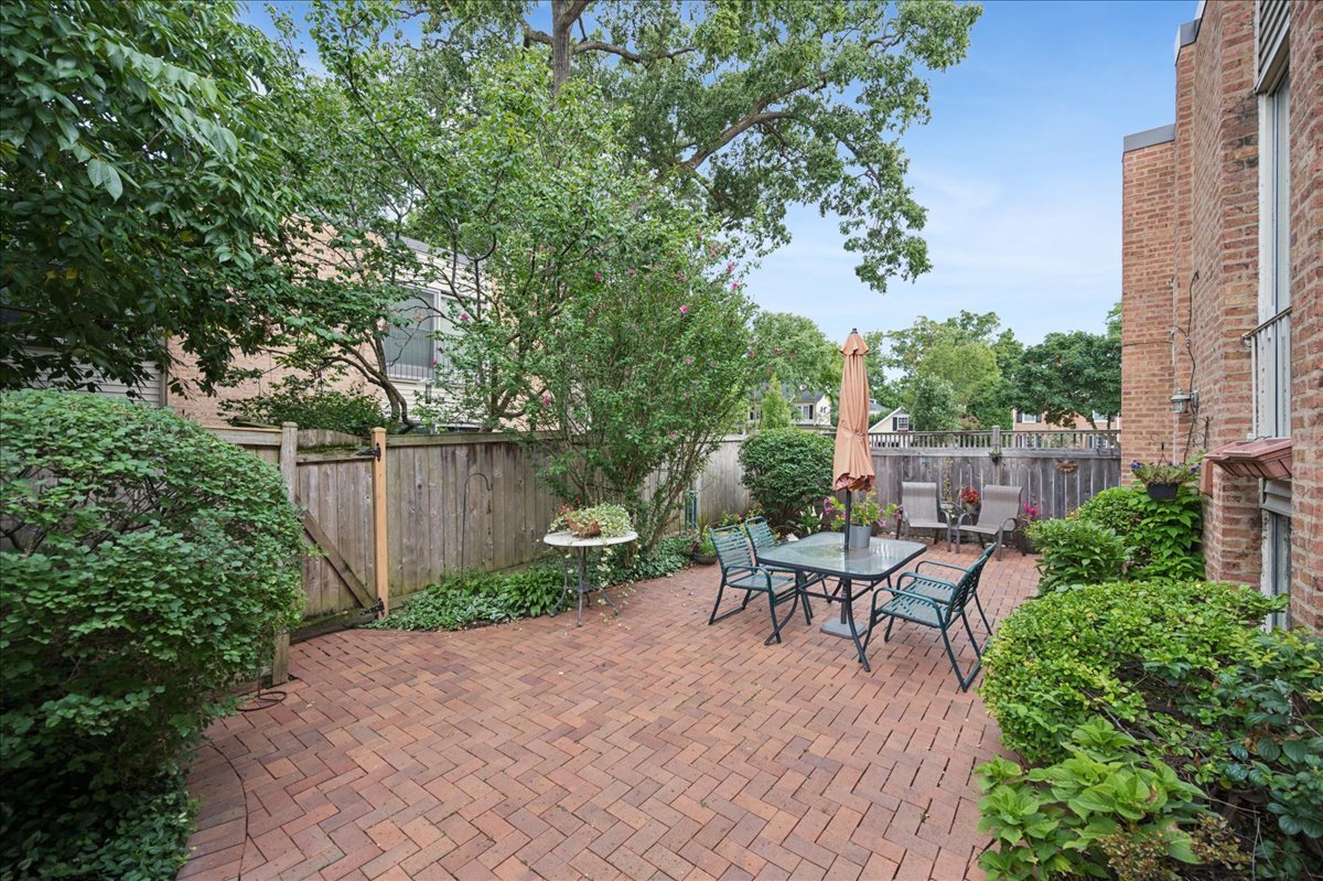 471 Linden Street Winnetka, IL 60093 - Photo 15 of 36 a view of a backyard with furniture and a garden