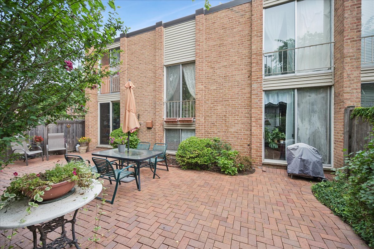 471 Linden Street Winnetka, IL 60093 - Photo 16 of 36 a backyard of a house with outdoor seating