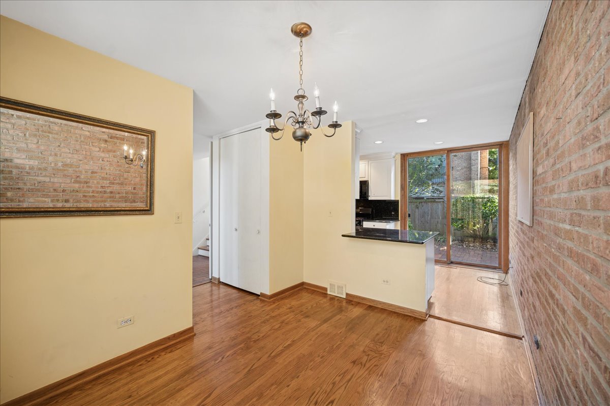 471 Linden Street Winnetka, IL 60093 - Photo 23 of 36 a view of a room with wooden floor fireplace and windows