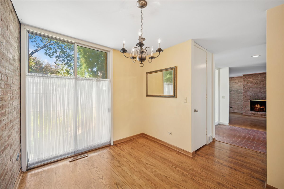 471 Linden Street Winnetka, IL 60093 - Photo 24 of 36 a view of a livingroom with wooden floor and a chandelier