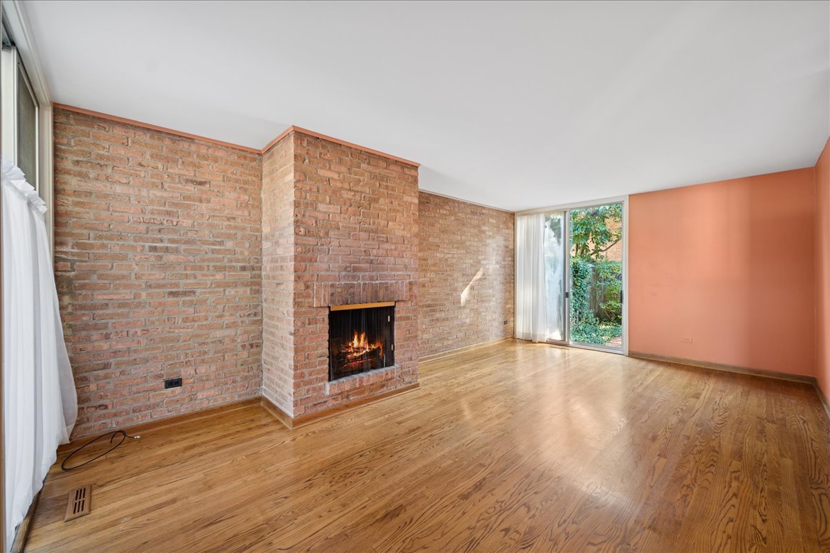471 Linden Street Winnetka, IL 60093 - Photo 27 of 36 a view of empty room with wooden floor and fireplace