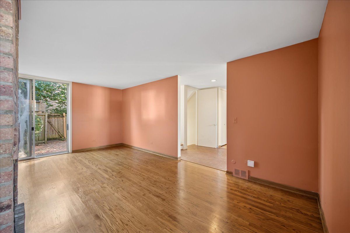 471 Linden Street Winnetka, IL 60093 - Photo 28 of 36 a view of an empty room with wooden floor and a window