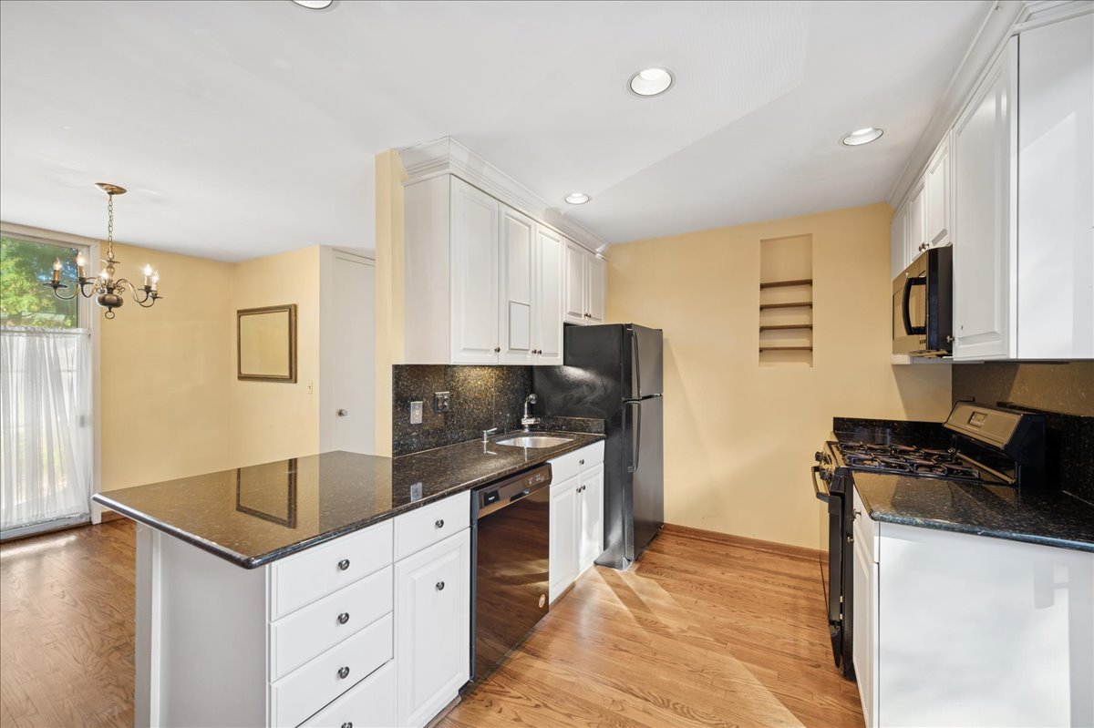 471 Linden Street Winnetka, IL 60093 - Photo 4 of 36 a kitchen with granite countertop a sink stove and refrigerator