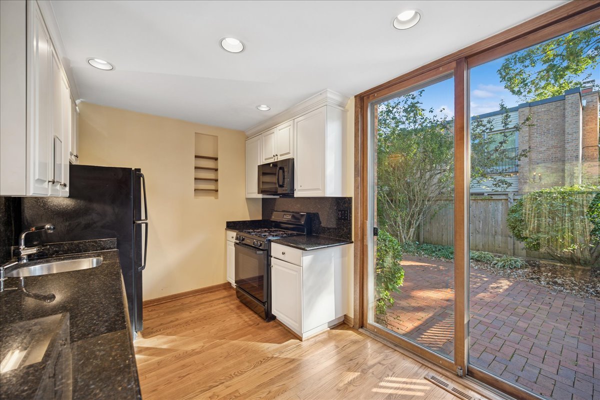 471 Linden Street Winnetka, IL 60093 - Photo 5 of 36 a kitchen with a sink a counter top space and stainless steel appliances