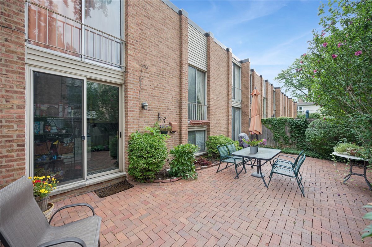 471 Linden Street Winnetka, IL 60093 - Photo 6 of 36 a view of a patio with couches table and chairs and potted plants