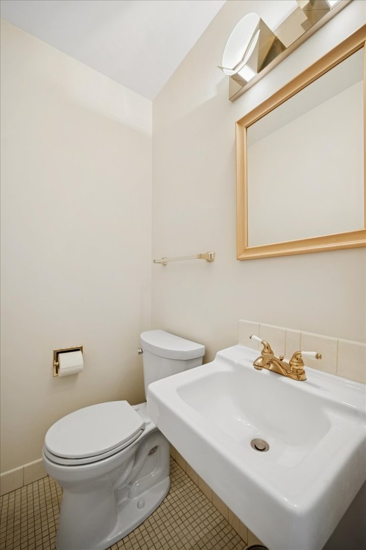 471 Linden Street Winnetka, IL 60093 - Photo 9 of 36 a white toilet sitting next to a bathroom sink
