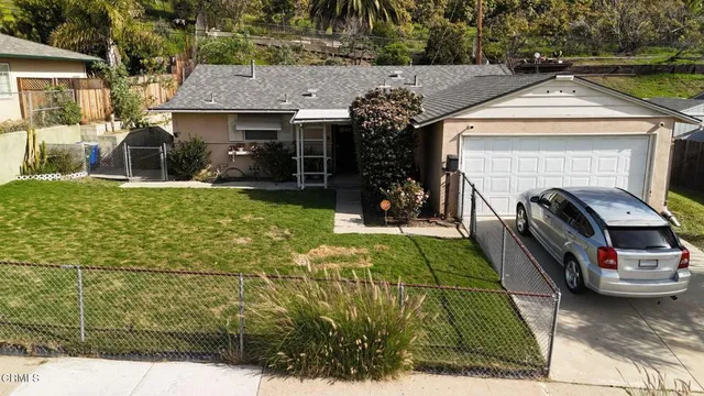 a view of a car park in front of house