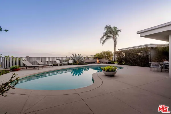 a view of a swimming pool and lounge chair