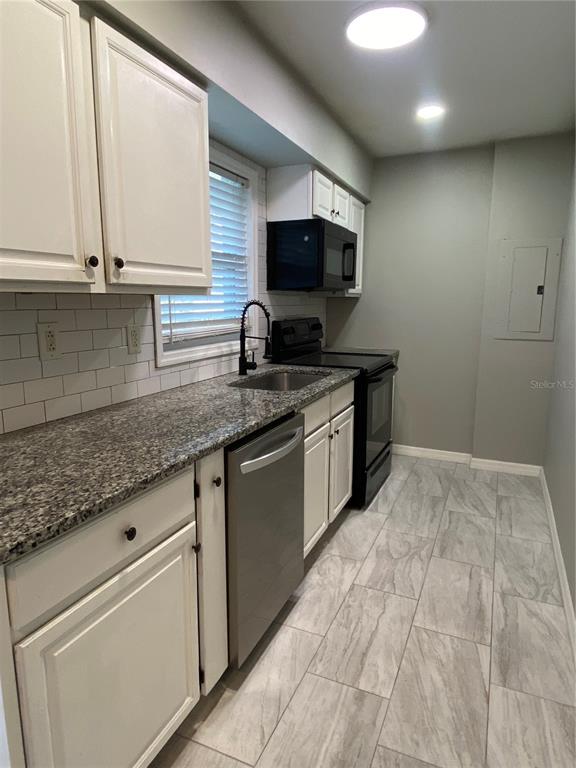 39656 Meadowood Loop Zephyrhills, FL 33542 - Photo 12 of 30 a kitchen with stainless steel appliances granite countertop a sink and a stove